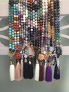 Several of the over 100 mala necklaces made for this organization - each necklace containing 108 individually tied beads, accent and guru beads.  Each custom made for the recipient.